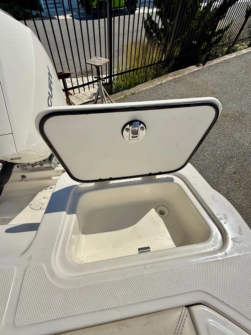Slide: The Image of An open storage compartment on a 2024 Boston Whaler 250 Outrage. - 38