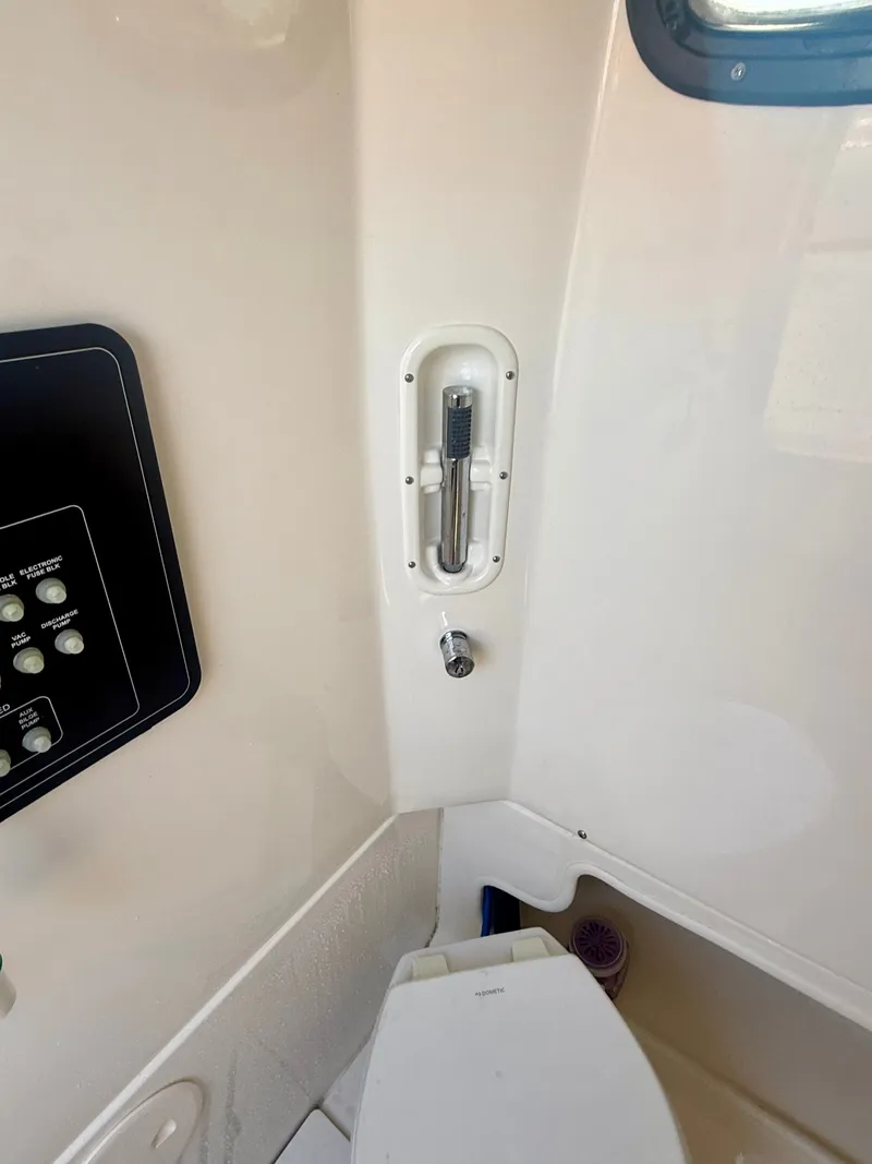 Slide: The Image of Interior view of a boat cabin with a toilet and control panel. - 22