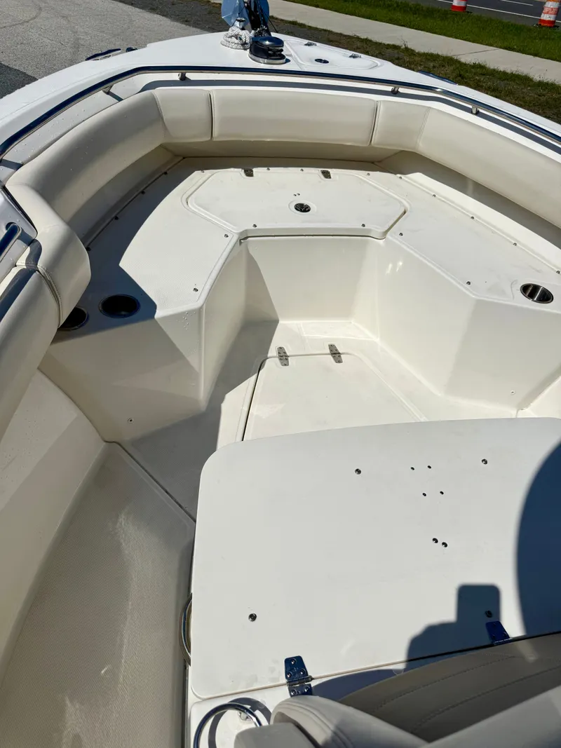 Slide: The Image of The image shows the bow area of a 2024 Boston Whaler 250 Outrage with cushioned seating. - 44