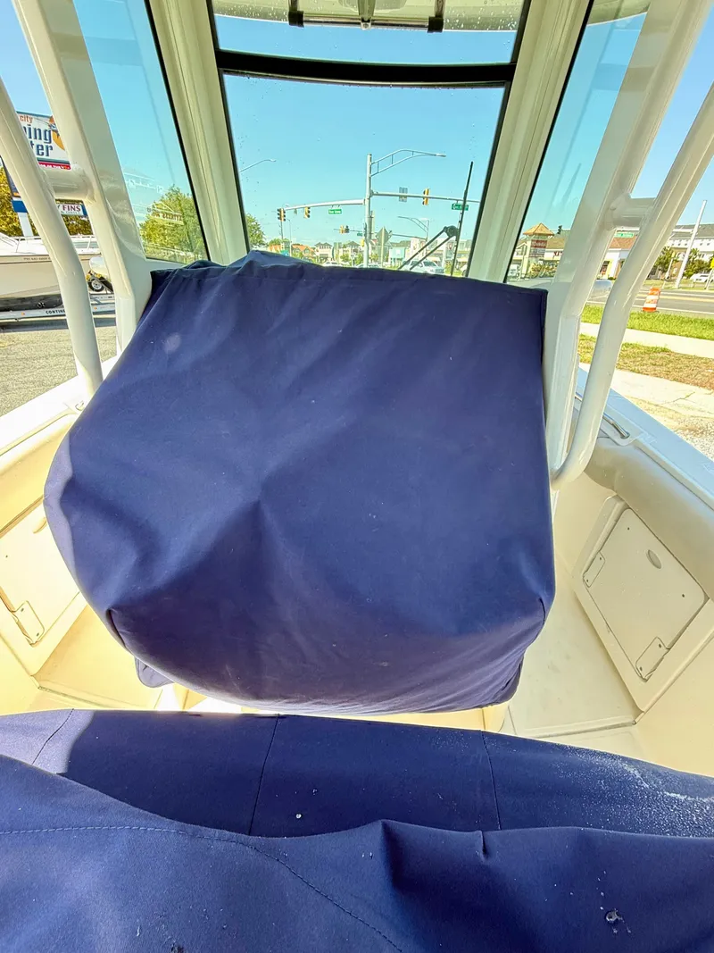 Slide: The Image of The image shows the interior of a 2024 Boston Whaler 250 Outrage with blue covers. - 41