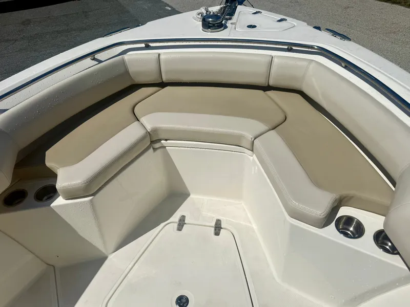 Slide: The Image of The 2024 Boston Whaler 250 Outrage features a spacious, cushioned seating area at the bow. - 28