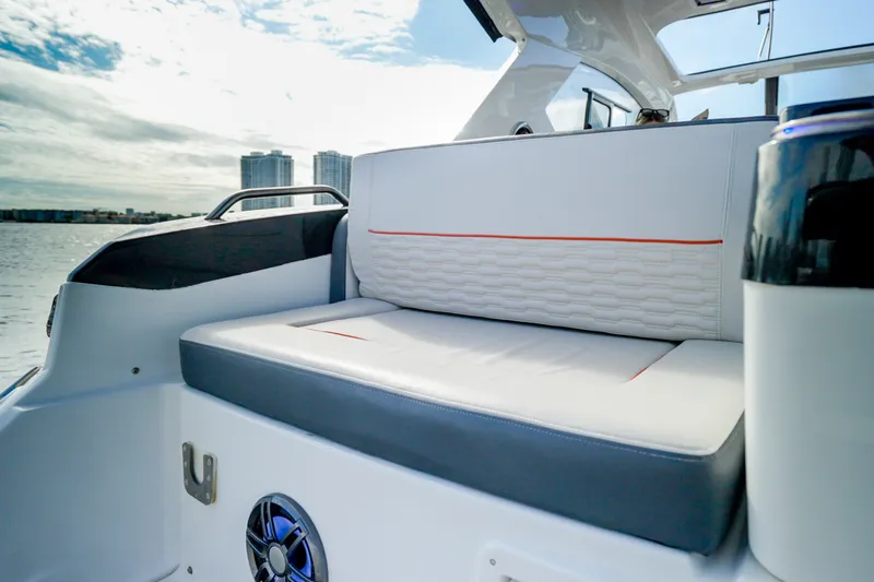 Slide: The Image of Luxurious seating on the 2026 Granfort 370 GTX yacht, with city skyline in background. - 18