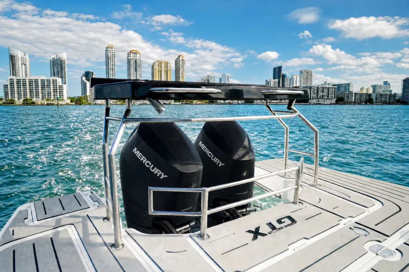 Slide: The Image of 2026 Granfort 370 GTX boat with dual Mercury engines on a sunny waterfront. - 14