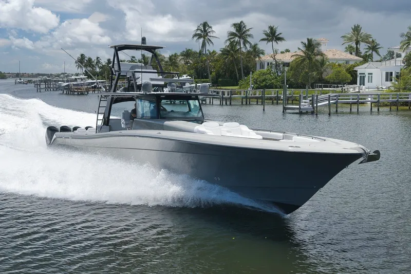 The Image of 2023 HCB 65 Estrella cruising on a scenic waterway with palm trees in the background. - 0