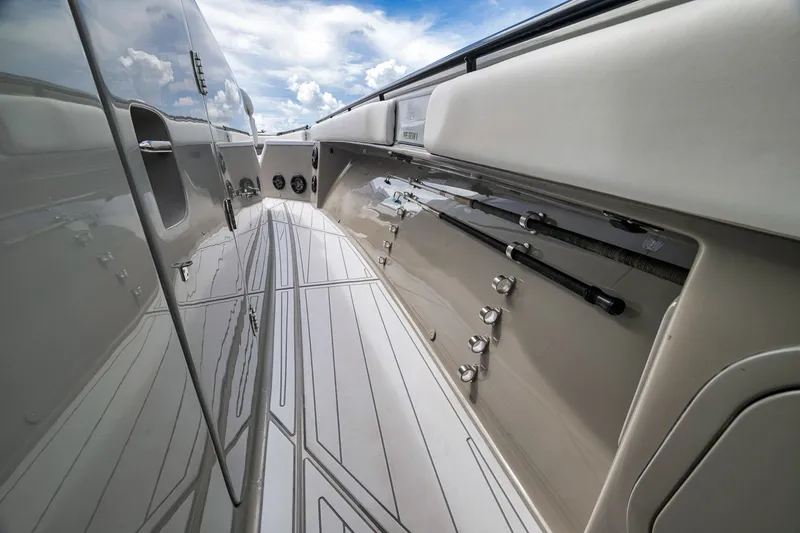 Slide: The Image of 2023 HCB 65 Estrella boat deck with sleek design and fishing rod holders. - 53