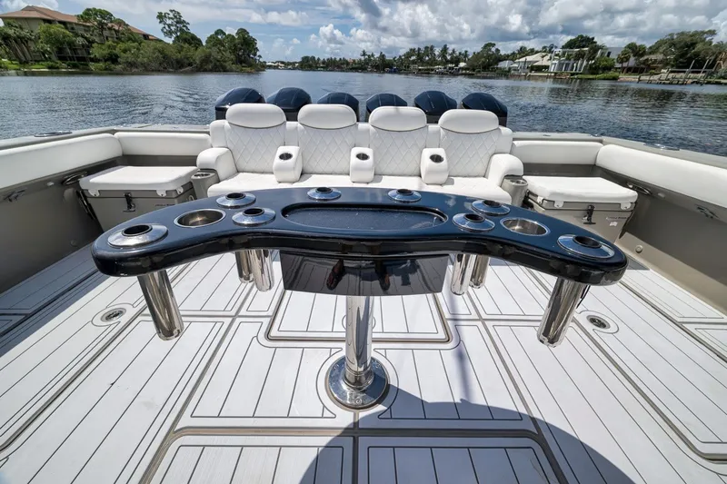 Slide: The Image of Luxury seating and table on 2023 HCB 65 Estrella boat, with scenic water view. - 66
