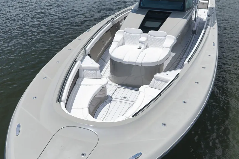 Slide: The Image of 2023 HCB 65 Estrella luxury boat with spacious seating on calm water. - 17