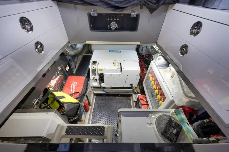 Slide: The Image of Engine room of 2023 HCB 65 Estrella boat with equipment and storage compartments. - 77
