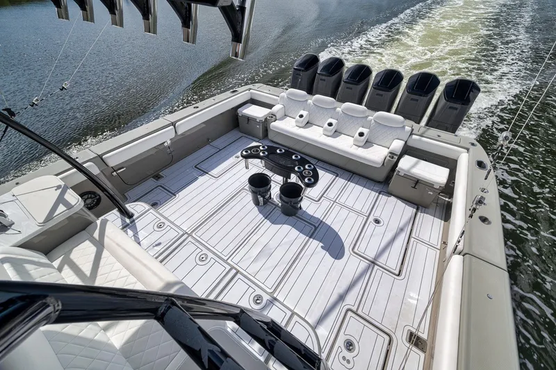 Slide: The Image of 2023 HCB 65 Estrella luxury boat deck with seating and multiple outboard engines. - 43