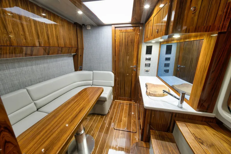 Slide: The Image of Luxurious 2023 HCB 65 Estrella yacht interior with wood finishes and modern seating area. - 32