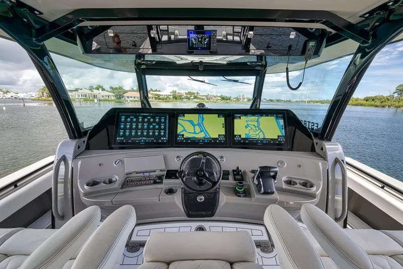 Slide: The Image of Luxurious 2023 HCB 65 Estrella boat cockpit with advanced navigation screens and controls. - 71