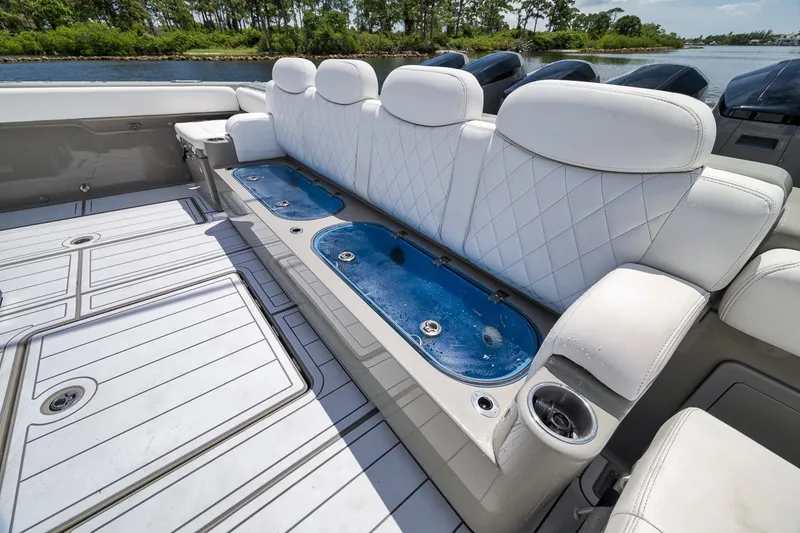 Slide: The Image of Luxurious seating on 2023 HCB 65 Estrella boat with integrated live wells and cup holders. - 76