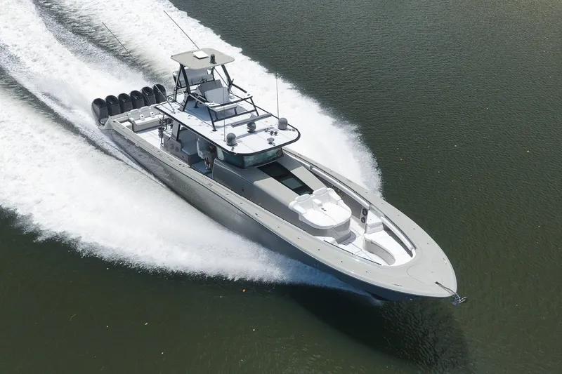 Slide: The Image of 2023 HCB 65 Estrella luxury boat cruising on water with powerful engines. - 4