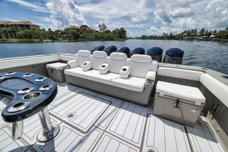 Slide: The Image of Luxurious 2023 HCB 65 Estrella boat interior with plush seating and scenic water view. - 65