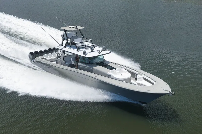 Slide: The Image of 2023 HCB 65 Estrella luxury boat cruising on water, showcasing sleek design and powerful engines. - 2