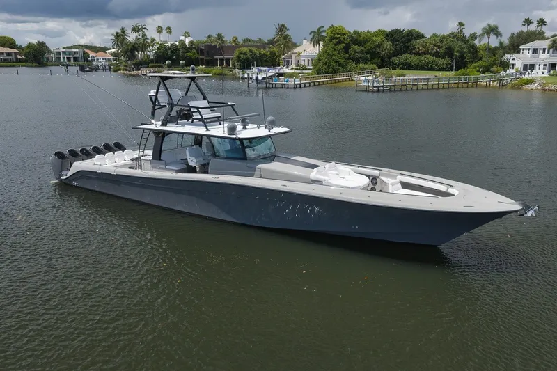 Slide: The Image of 2023 HCB 65 Estrella luxury yacht on calm waters, surrounded by lush greenery. - 9