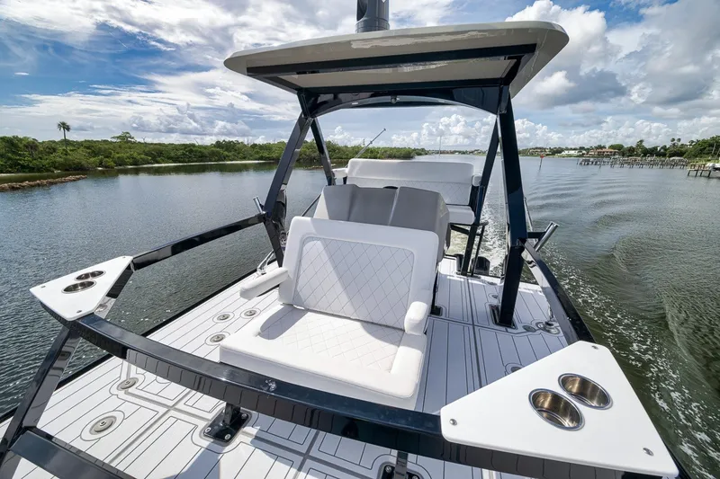 Slide: The Image of 2023 HCB 65 Estrella luxury boat cruising on a scenic waterway under a partly cloudy sky. - 40