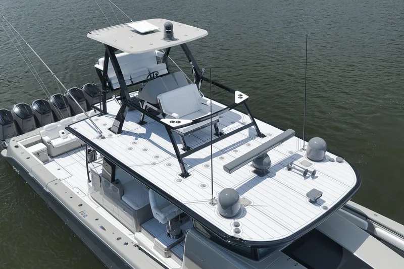 Slide: The Image of 2023 HCB 65 Estrella luxury boat with spacious deck and multiple engines on water. - 20