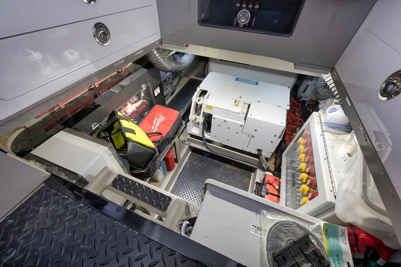 Slide: The Image of Engine room of 2023 HCB 65 Estrella boat with equipment and storage compartments. - 78
