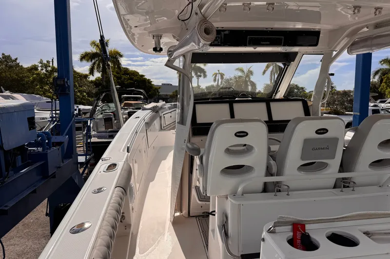 Slide: The Image of 2016 Everglades 435 Center Console boat interior with Garmin equipment and seating. - 14