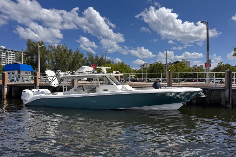Slide: The Image of 2016 Everglades 435 Center Console boat docked at marina under blue sky. - 3