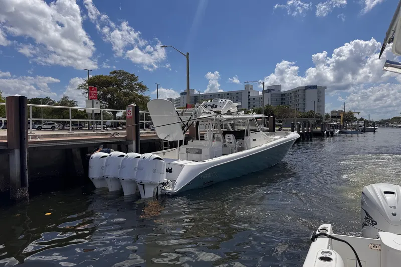 Slide: The Image of 2016 Everglades 435 Center Console boat docked at marina under blue sky. - 1