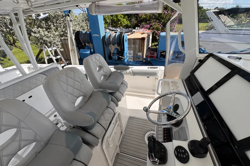 Slide: The Image of Interior of 2016 Everglades 435 Center Console boat with modern helm and seating. - 19
