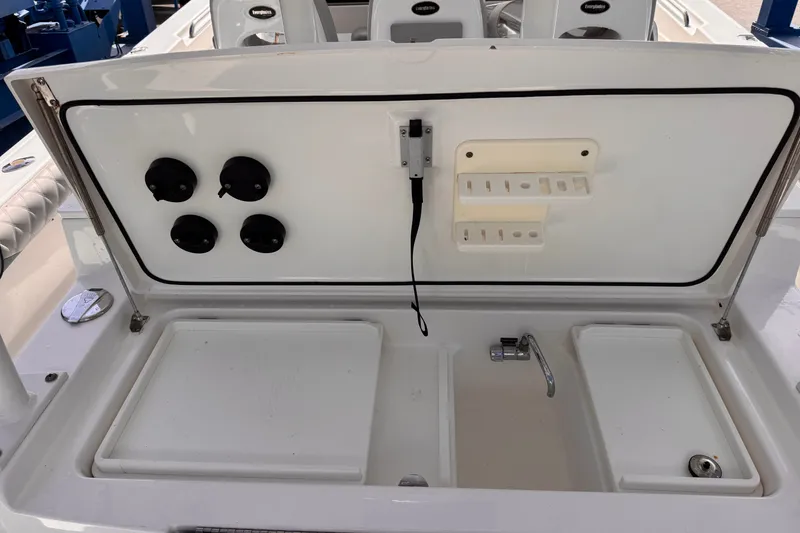 Slide: The Image of 2016 Everglades 435 Center Console boat with open storage compartment and faucet. - 23