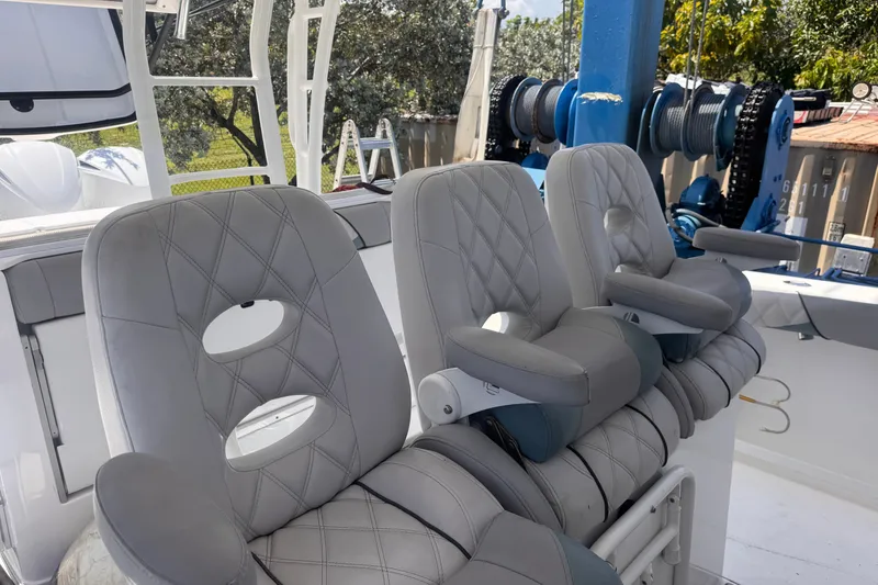 Slide: The Image of Luxurious seating on a 2016 Everglades 435 Center Console boat, featuring plush gray upholstery. - 17