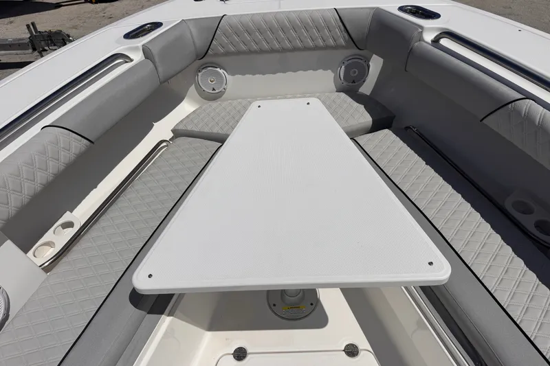 Slide: The Image of Interior of 2016 Everglades 435 Center Console boat with cushioned seating and table. - 12