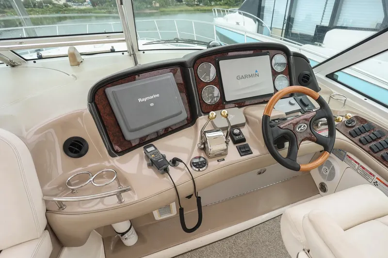 Slide: The Image of Helm of 2006 Sea Ray 52 Sundancer with Raymarine and Garmin navigation systems. - 15