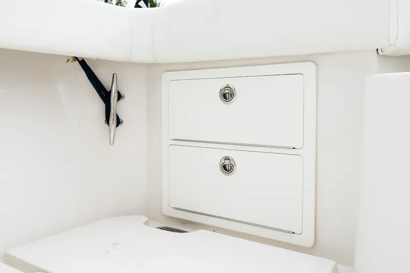 Slide: The Image of White storage compartments on a 2021 Jupiter 43 boat, featuring sleek design and secure latches. - 22