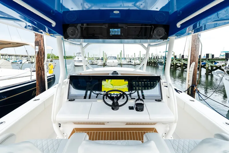 Slide: The Image of Interior view of a 2021 Jupiter 43 boat cockpit at a marina. - 36