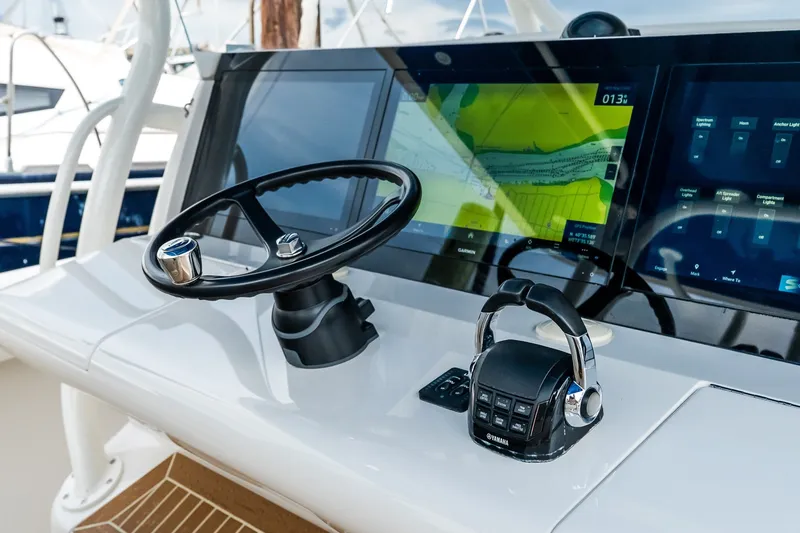Slide: The Image of Steering console of 2021 Jupiter 43 boat with navigation screens and controls. - 43