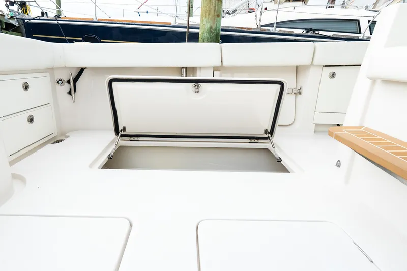 Slide: The Image of Open storage compartment on a 2021 Jupiter 43 boat deck, showcasing spacious interior. - 20