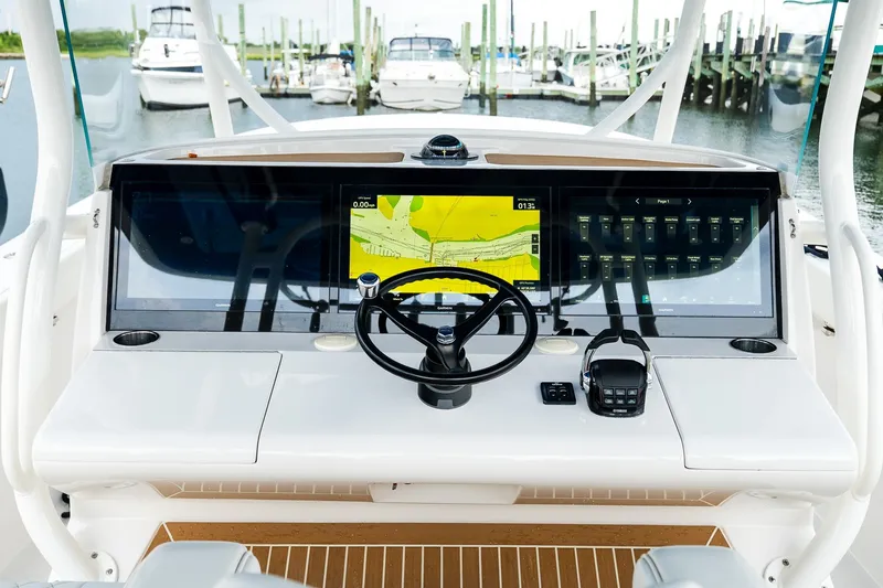 Slide: The Image of Cockpit of 2021 Jupiter 43 boat with advanced navigation system and steering wheel. - 42