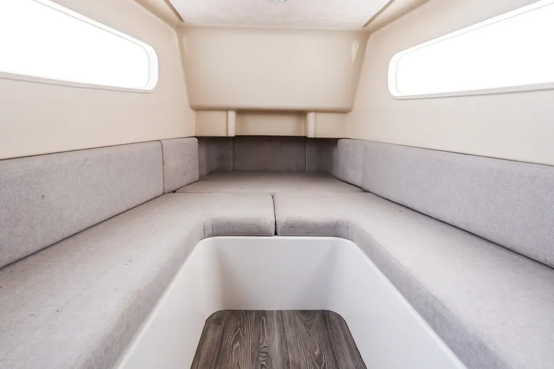 Slide: The Image of Interior cabin of 2021 Jupiter 43 boat with gray seating and wood flooring. - 63