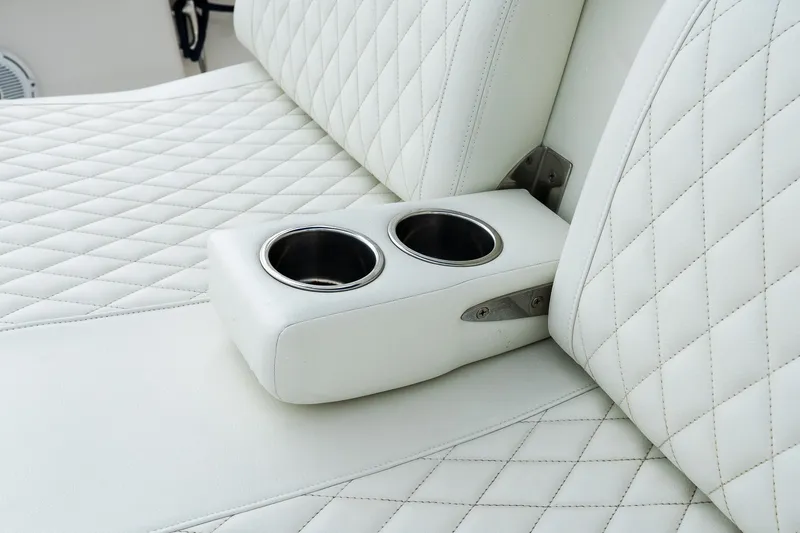 Slide: The Image of Luxurious white quilted seating with cup holders in a 2021 Jupiter 43 boat. - 32