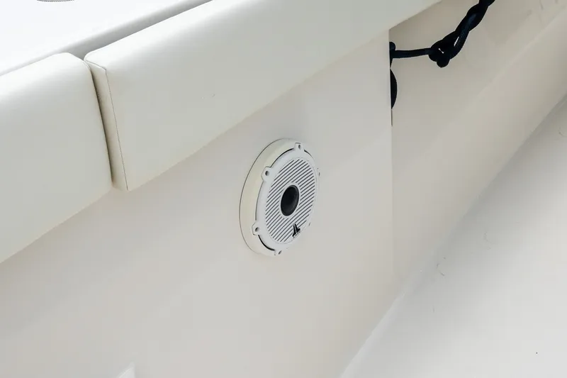 Slide: The Image of White interior of 2021 Jupiter 43 boat with speaker and cushioned seating. - 45