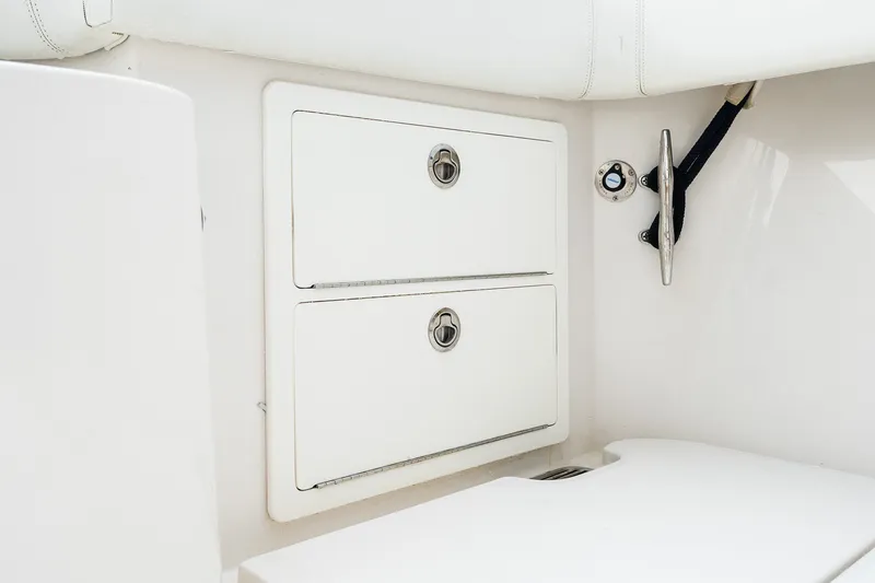 Slide: The Image of Storage compartments on a 2021 Jupiter 43 boat, featuring sleek white design and secure latches. - 21