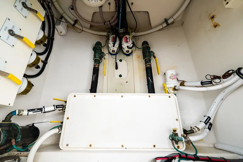 Slide: The Image of Engine compartment of a 2021 Jupiter 43 boat, showcasing plumbing and wiring systems. - 70