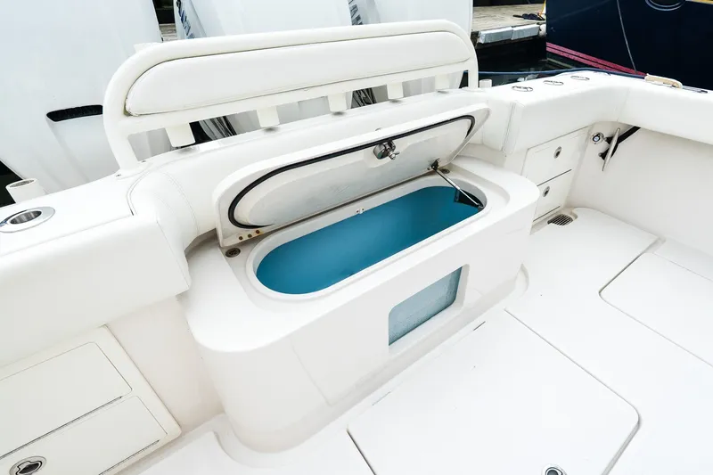 Slide: The Image of 2021 Jupiter 43 boat interior with open storage compartment, white seating, and sleek design. - 18