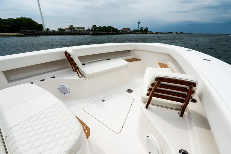 Slide: The Image of Luxurious 2021 Jupiter 43 boat interior with white seating, on calm waters. - 71