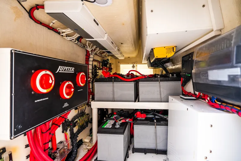 Slide: The Image of Electrical system of a 2021 Jupiter 43 boat, featuring batteries and control panel. - 74