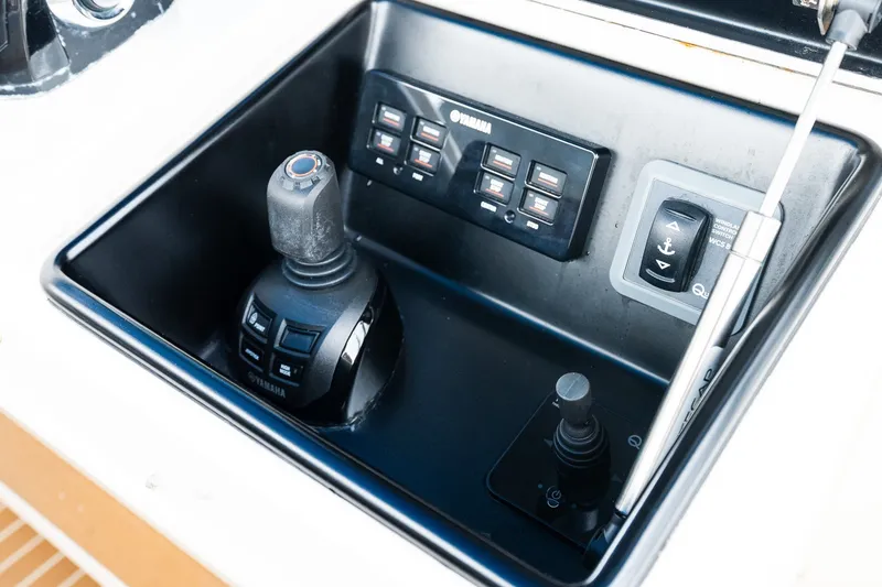 Slide: The Image of Control panel of a 2021 Jupiter 43 boat featuring Yamaha joystick and switches. - 44