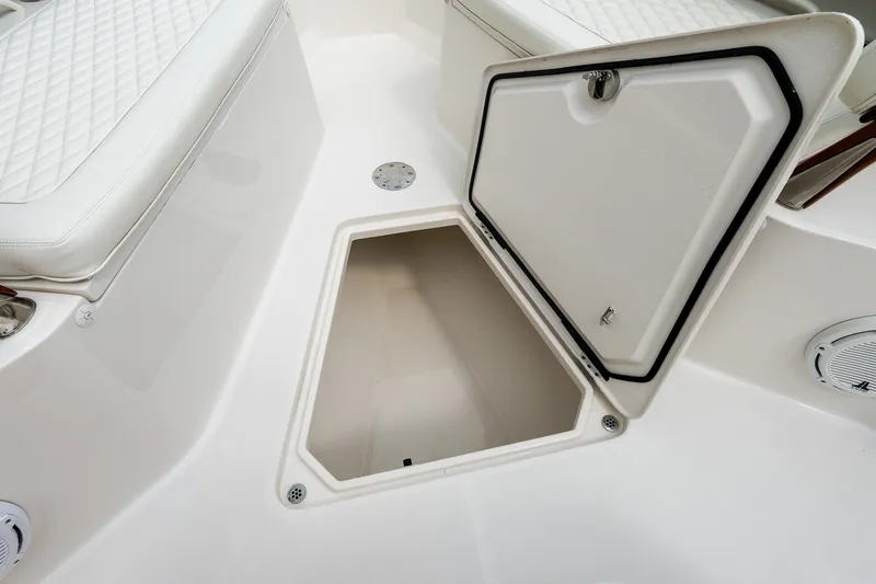 Slide: The Image of Open storage compartment on 2021 Jupiter 43 boat with quilted seating. - 58