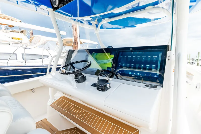 Slide: The Image of Helm of 2021 Jupiter 43 boat with modern controls and navigation display. - 40