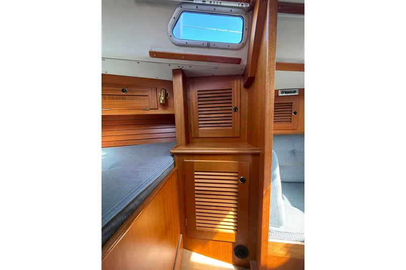 Slide: The Image of Interior of 1995 Hallberg-Rassy 34 sailboat, featuring wooden cabinetry and a skylight. - 13