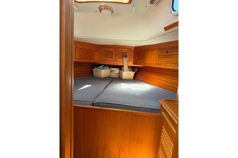 Slide: The Image of Cozy cabin interior of 1995 Hallberg-Rassy 34 sailboat with wooden finish and storage. - 15