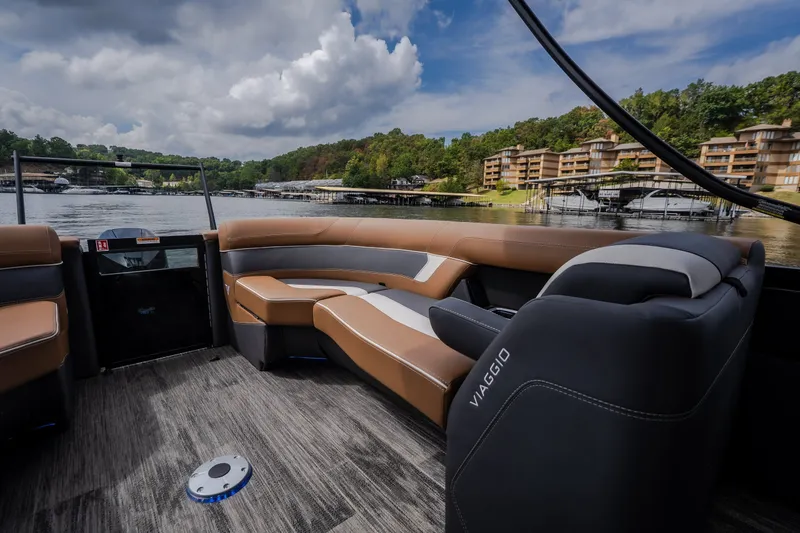 Slide: The Image of Luxurious Viaggio Diamante U 26 boat interior with plush seating, overlooking serene lake and modern buildings. - 39